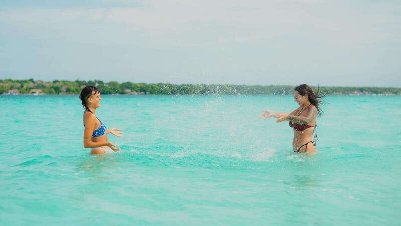 Bacalar Lagoon Sightseeing Boat Tour with Open Bar & Snack - Isla de los Pajaros: scenic views, photo time, and another swim stop