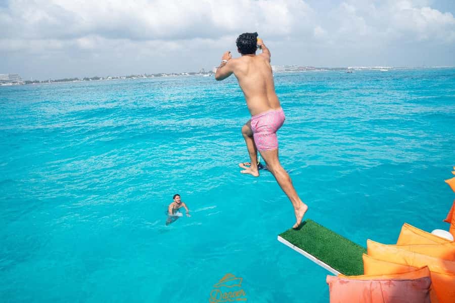 Cancun: Isla Mujeres Full Day Dancer Cruise - Onboard energy: slide time, jump boards, and the DJ dance floor