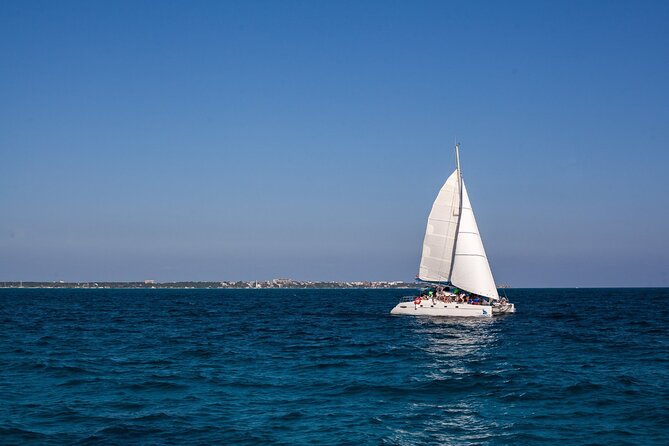 Cancun Sailing Catamaran Islas Mujeres With Luxury Beach Club - The 8-hour flow: catamaran cruise, El Meco Reef snorkel, then open bar and lunch