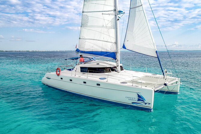 Isla Mujeres Catamaran Tour with Open Bar, Lunch and Snorkeling - Isla Mujeres beach club stop: buffet lunch, beach time, and managing the lines